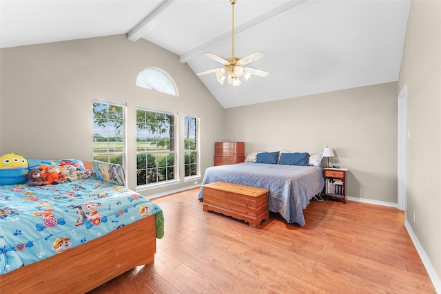 bedroom with multiple windows, light hardwood / wood-style floors, ceiling fan, and beamed ceiling