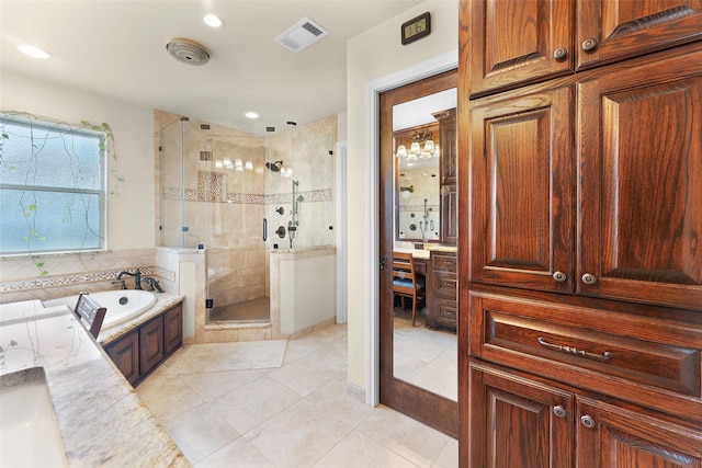 bathroom with tile patterned floors, vanity, and independent shower and bath