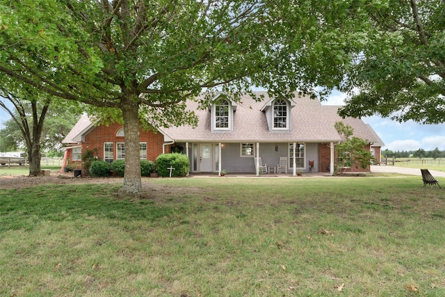 new england style home featuring a front lawn