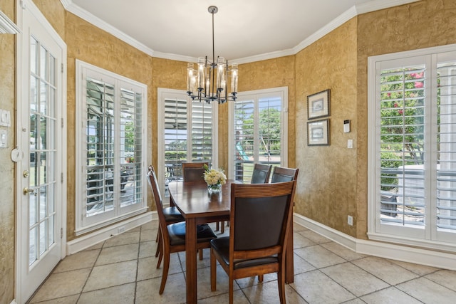 tiled dining room featuring ornamental molding, a healthy amount of sunlight, and a notable chandelier