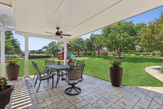 view of patio / terrace with ceiling fan and a playground