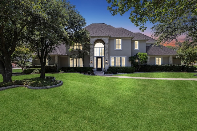 view of front of house with a front lawn and stone siding