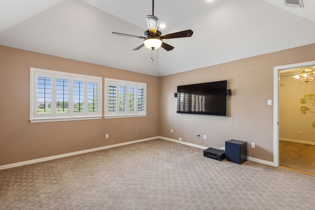 interior space with carpet flooring, ceiling fan, vaulted ceiling, and a healthy amount of sunlight