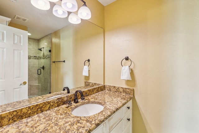 bathroom featuring vanity and a shower with shower door