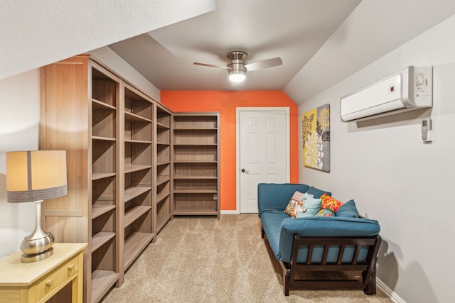 sitting room with lofted ceiling, an AC wall unit, light carpet, and ceiling fan