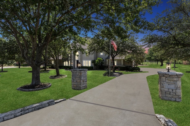 view of home's community with a lawn and driveway