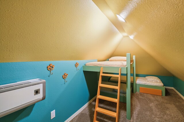 carpeted bedroom with a textured ceiling and lofted ceiling