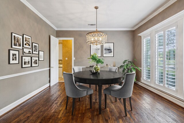 living room featuring ornate columns, a notable chandelier, hardwood / wood-style floors, and crown molding