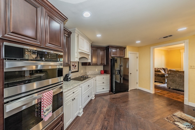 kitchen featuring backsplash, white cabinets, black appliances, and dark hardwood / wood-style floors