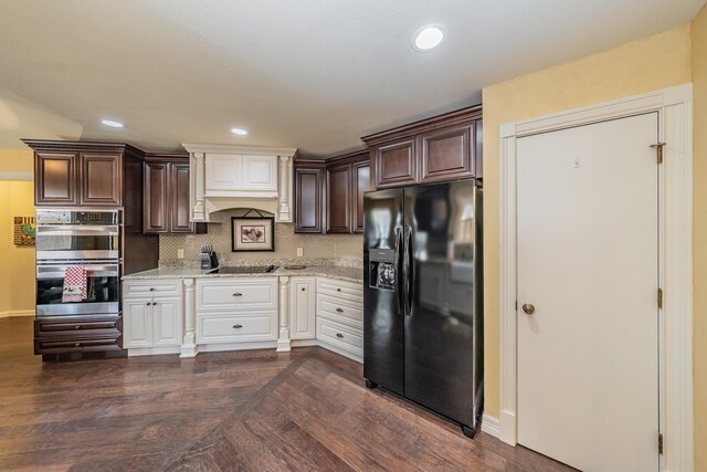 kitchen with black appliances, white cabinets, tasteful backsplash, and light stone counters