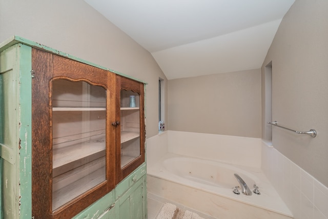 bathroom featuring vaulted ceiling and a bathing tub