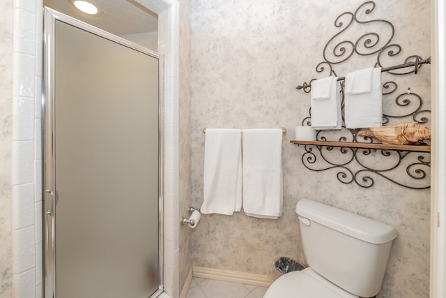 bathroom featuring an enclosed shower, toilet, and tile floors