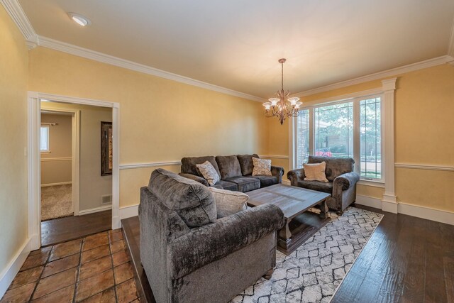 living room with a notable chandelier, ornamental molding, and dark hardwood / wood-style flooring