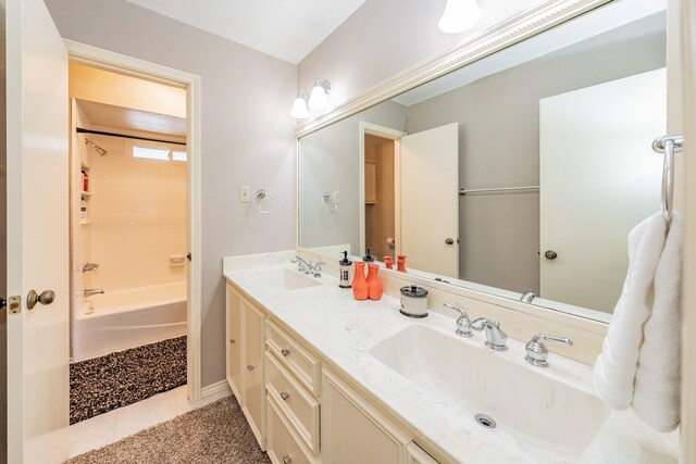 bathroom with tile flooring, double sink vanity, and  shower combination