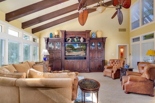 carpeted living room with beamed ceiling, high vaulted ceiling, and ceiling fan