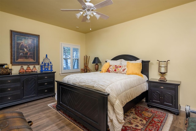 bedroom featuring ceiling fan and dark wood-type flooring