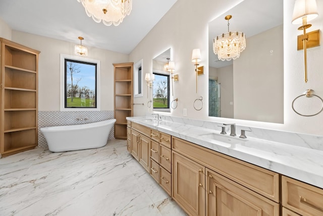 bathroom featuring shower with separate bathtub, vanity, and an inviting chandelier