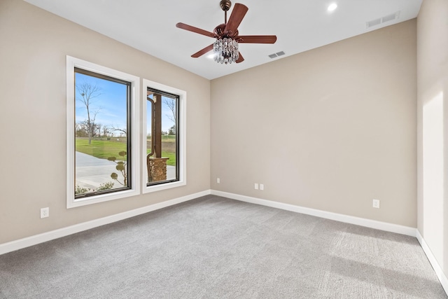 carpeted spare room with ceiling fan