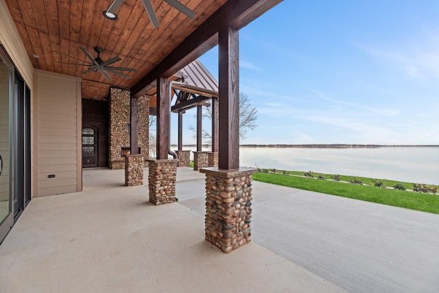 view of patio featuring a water view and ceiling fan