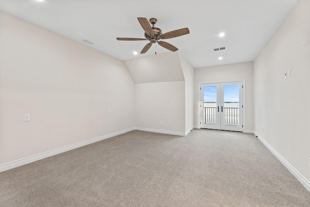 bonus room with vaulted ceiling, french doors, ceiling fan, and light colored carpet