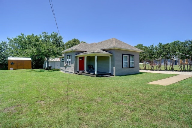 rear view of house featuring a yard