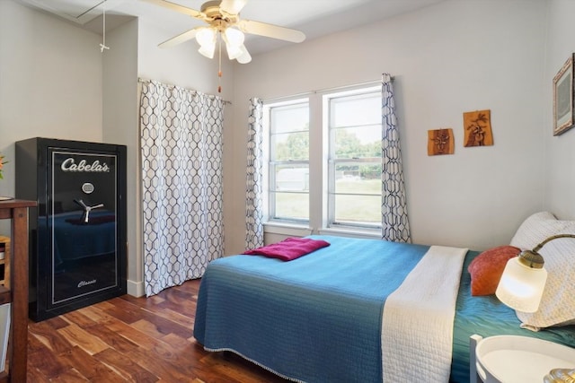 bedroom with dark hardwood / wood-style flooring and ceiling fan