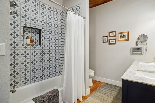 full bathroom with shower / bath combo, hardwood / wood-style flooring, toilet, and vanity