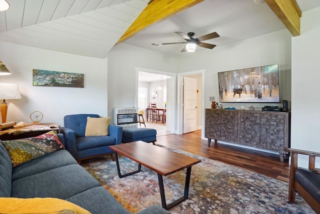 living room featuring ceiling fan, vaulted ceiling with beams, and hardwood / wood-style floors