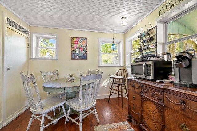 dining area with a wealth of natural light, dark hardwood / wood-style floors, and crown molding