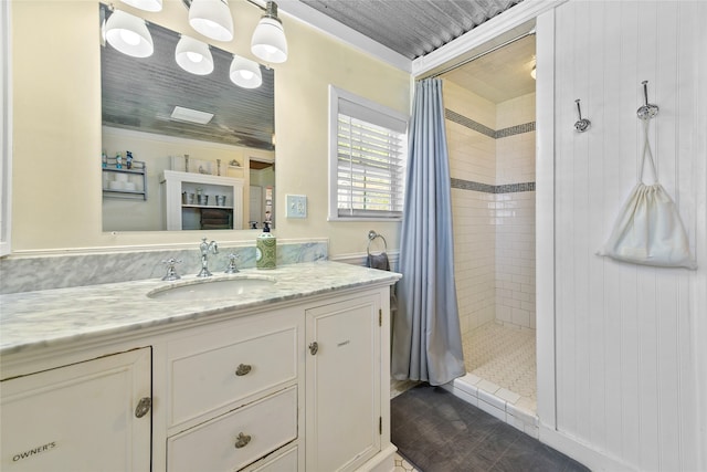 bathroom with walk in shower, vanity, and crown molding