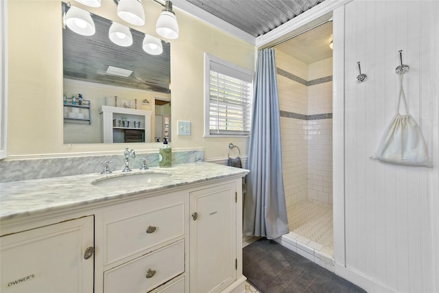 bathroom with a shower stall and vanity