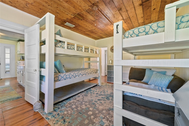 bedroom with wooden ceiling and hardwood / wood-style flooring