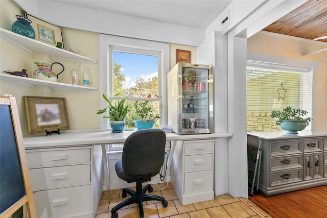 office with light tile patterned floors, wine cooler, and built in desk