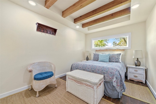 bedroom with beam ceiling and hardwood / wood-style floors