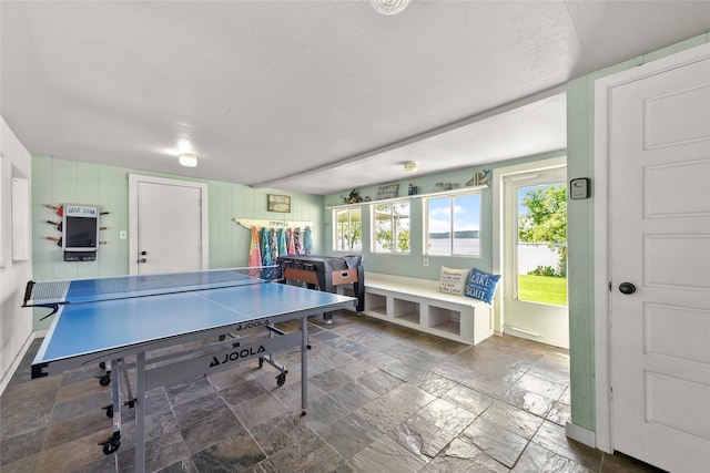 playroom with stone tile floors and a wealth of natural light