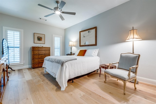 bedroom with ceiling fan and light wood-type flooring