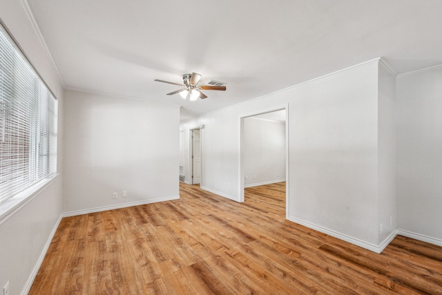 unfurnished room featuring ornamental molding, ceiling fan, and light wood-type flooring