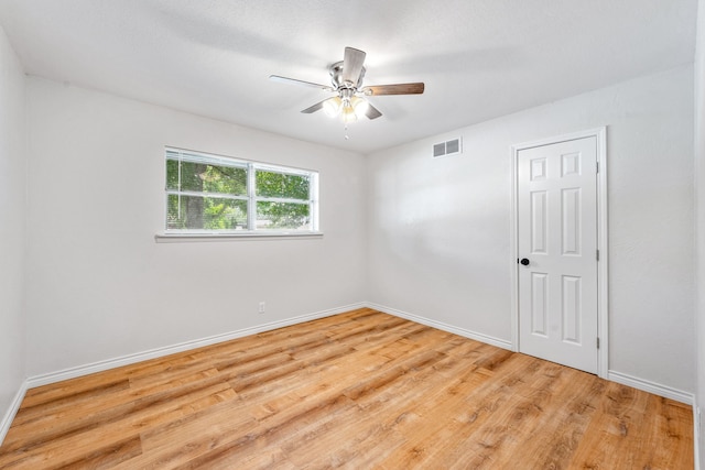 empty room featuring ceiling fan and light hardwood / wood-style floors