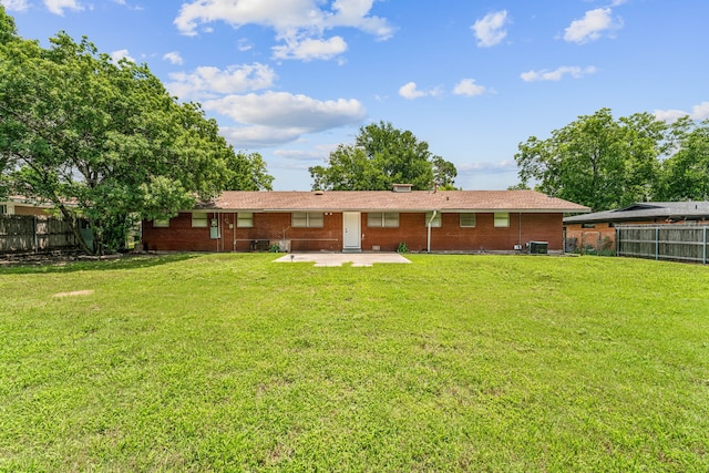 back of property featuring a patio area, central air condition unit, and a lawn