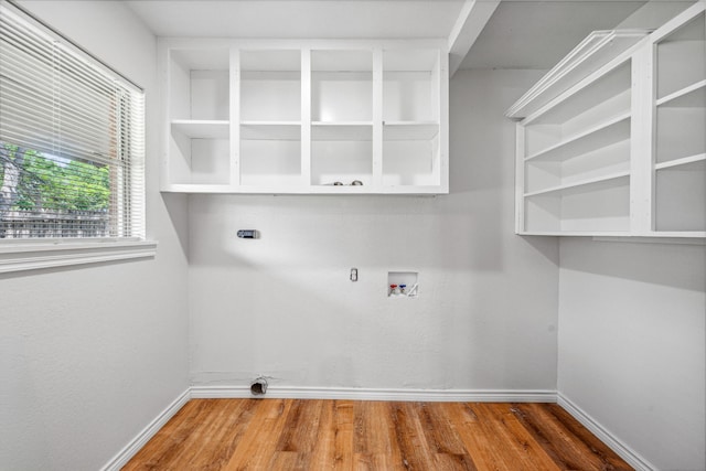 washroom with hookup for a washing machine, hardwood / wood-style floors, and electric dryer hookup