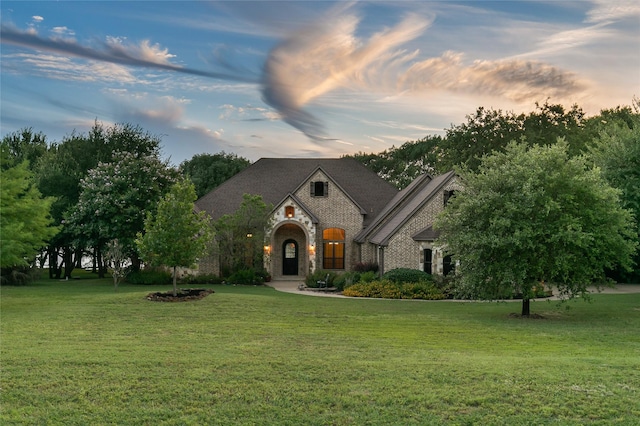 tudor-style house with a front lawn