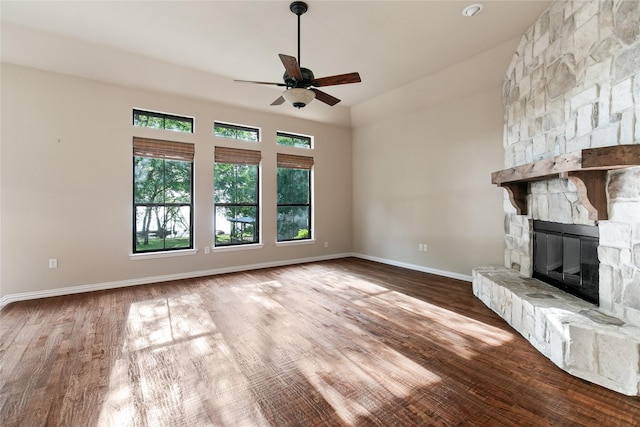 unfurnished living room with a fireplace, ceiling fan, and hardwood / wood-style flooring