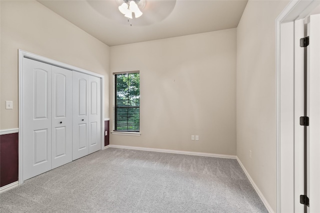 unfurnished bedroom with a closet, ceiling fan, and light colored carpet