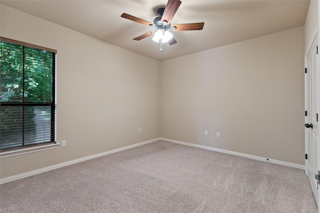 carpeted empty room featuring ceiling fan