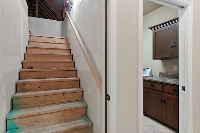 stairway featuring tile patterned flooring