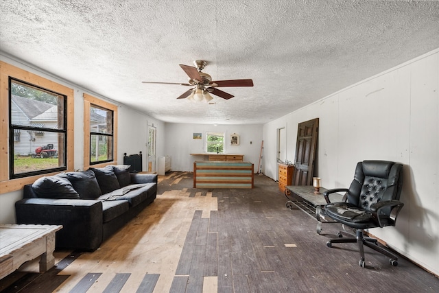 living room featuring a textured ceiling, ceiling fan, and hardwood / wood-style floors