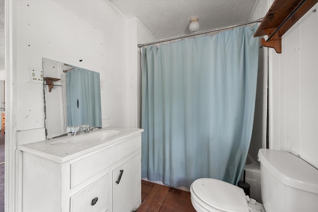 full bathroom with shower / bath combo, vanity with extensive cabinet space, a textured ceiling, and toilet