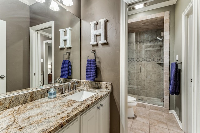 bathroom featuring tile patterned flooring, an enclosed shower, crown molding, toilet, and vanity