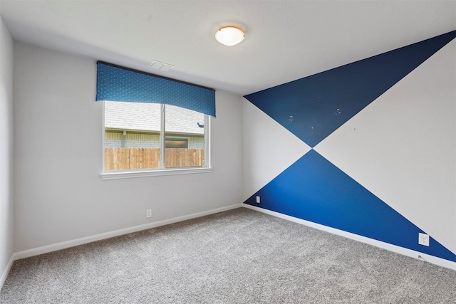 empty room with carpet floors and vaulted ceiling