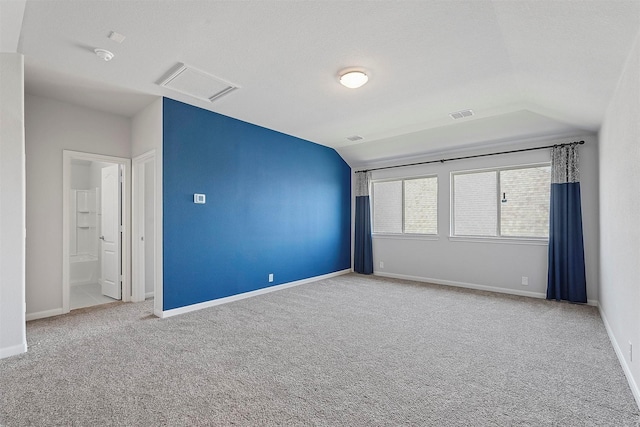 empty room featuring carpet and a textured ceiling